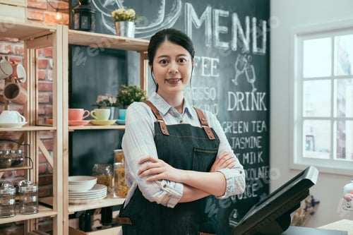 Preview: Portrait Of Happy Young Asian Woman Wearing Apron And Standing In Cafe Counter. Female Barista