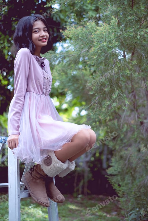 Preview: Portraits Smiling Asian Young Girl With Pine Tree In Vintage Color.