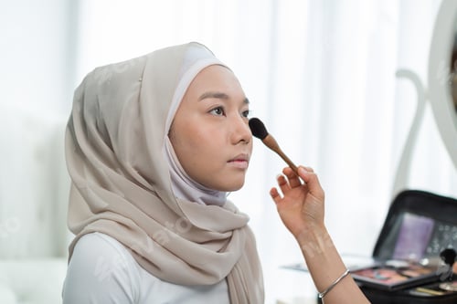 Preview: Makeup Artist Applying Powder With Brush Eyes Shadow With Young Muslim Woman In Hijab Head Scarf