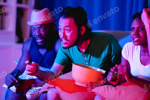 Preview: Friends Watching Soccer Eating Popcorn On Sofa. Asian Man And Woman With African American. Very