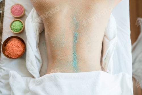 Preview: Young Beautiful Asian Woman Relaxing In The Spa Massage And Having Salt Scrub Massage At Back