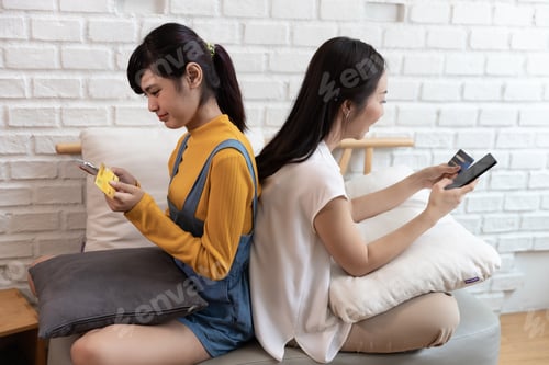 Preview: Girls With Electronic Devices Sitting Back To Back