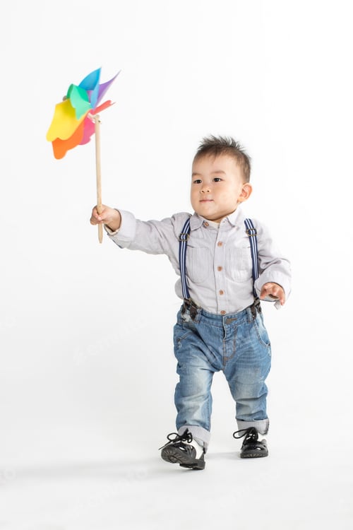 Preview: Cute Chinese Baby, Holding Him Windmill In A White Background In Studio