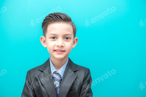 Preview: Young Boy In Business Suit Isolated In Blue. Handsome Early Teenage Boy Portrait Wearing Business