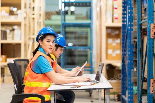 Preview: Group Of Asian Male And Female Warehouse Worker In Safety Vest And Helmet Working With Computer