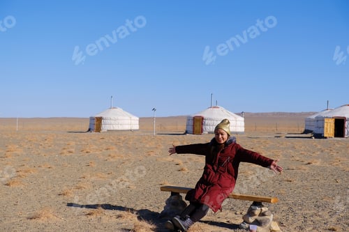Preview: Asia Tourist Woman Sit Down At Gobi Desert National Park At Mongolia.With Gobi Desert Background.