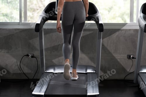 Preview: Woman Walking On A Treadmill For Exercising In A Gym. Fitness And Healthy Lifestyle Concept.