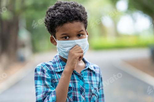Preview: Disease Virus And Air Pollution Pm 2.5 Concept. Boy Put On A Protective Medical Mask For Protect