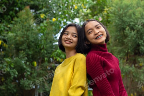 Preview: Two Happy Student Young Girl With Green Background.
