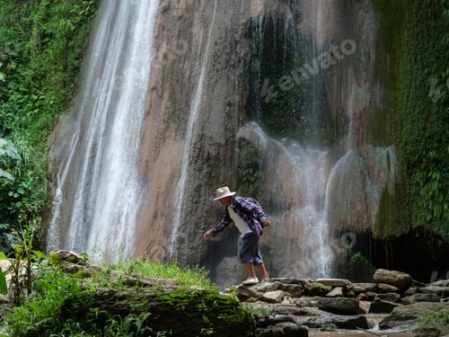 Preview: Senior Man With Backpacks Walking At Waterfall. Adventure, Travel, Tourism Concept.