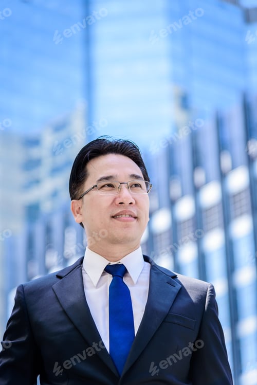 Preview: The Asian Businessman Has Thinking Of Vision With Building And City Background.