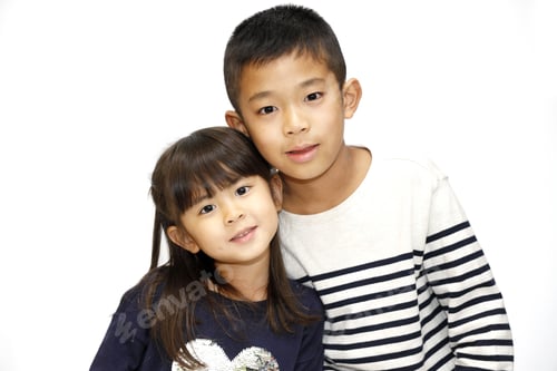 Preview: Brother and Sister Posing Together Indoors Smiling