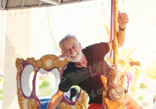 Preview: Smiling Senior Man On Horse Carousel Ride At The Amusement Theme Park, Male Senior Tourist, Elderly