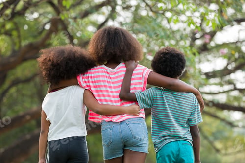 Preview: Group Of Smiling African American Children Playing And Hugging Together Outdoor And Looking At