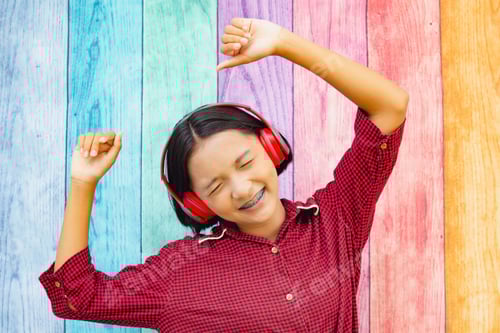 Preview: Happy Young Girl Listening To Music With Colorful Background.