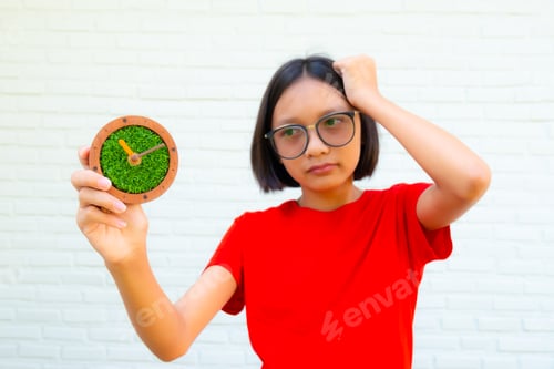 Preview: Young Pretty Girl With Short Hair Wear Red Shirt Holding Vintage Clock On Wall Background 11.05Am.