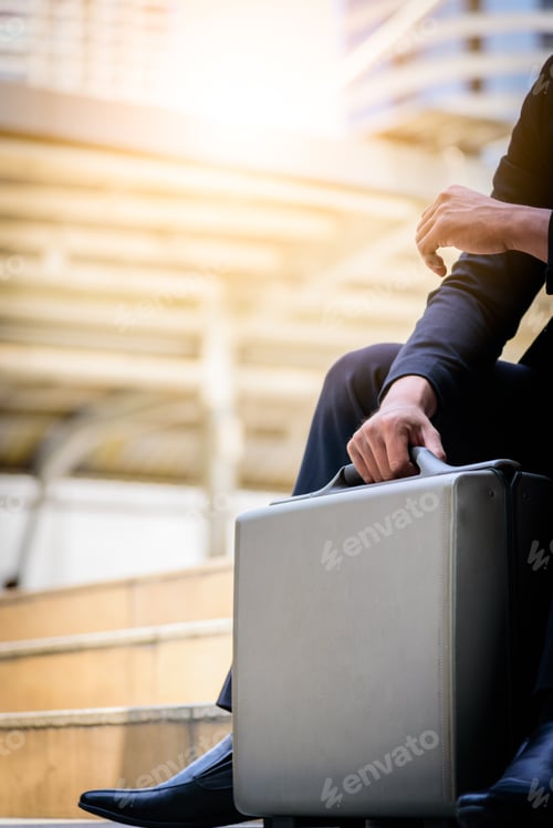 Preview: The Asian Businessman Has Holding A Black Bag.