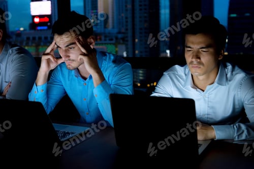 Preview: Working Overtime Concept. Group Of Young Business Team Working Late At Night In Meeting Room Trying