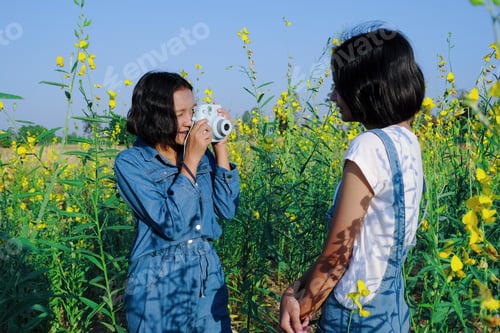 Preview: Happy Asian Young Girl Enjoy Taking Picture At Flower Garden.