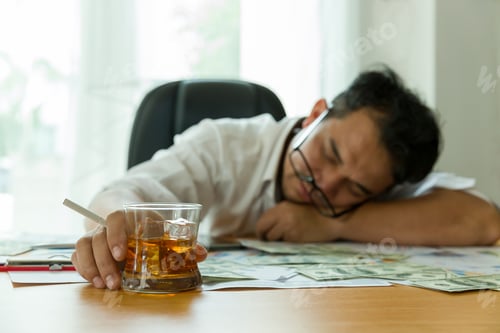 Preview: Stressed Adult Asian Businessman At Workplace And Drinking Alcohol With Many Document Paper For