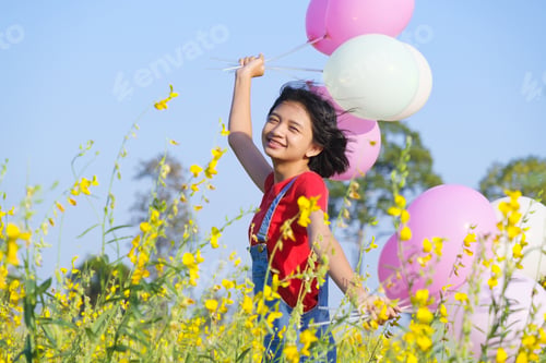 Preview: Happy Asian Young Girl At Flower Garden On Summer With Nice Sky.