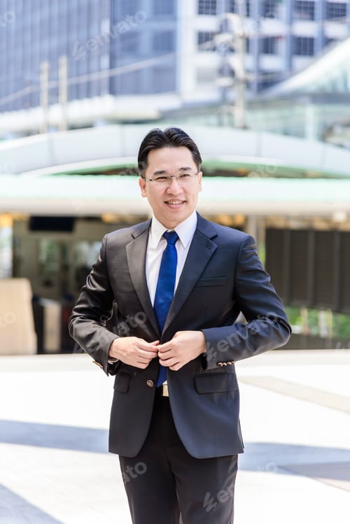 Preview: Asian Businessman Buttoning A Black Suit