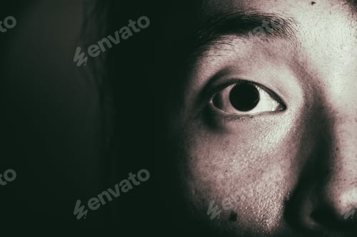 Vista previa: Extreme Close Up Of Young Chinese Male Eye With Dark Background. Asian Male. High Contrast