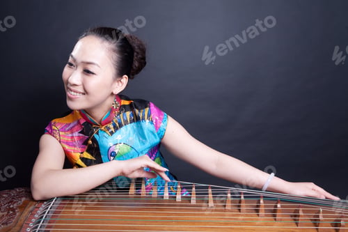 Preview: Girl Sitting And Playing Chinese Zither