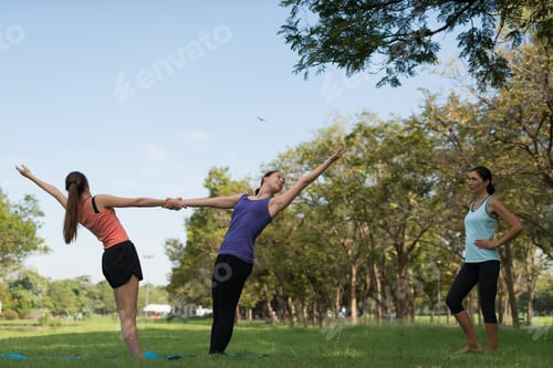 Preview: Family Practicing Yoga In The Park Outdoor. Concept Of Healthy Lifestyle And Relaxation.