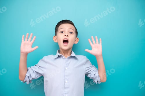 Preview: Young Boy Isolated In Blue. Handsome Early Teenage Boy Portrait. Happy Smile Surprise Pose.