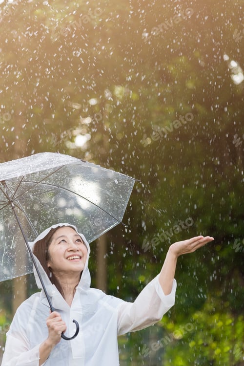 Preview: Asian Woman With Umbrella Checking For Rain With Happy And Smile.