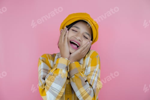 Preview: Happy Asia Young Girl Wear Yellow Shirt And Yellow Hat With Pink Background.