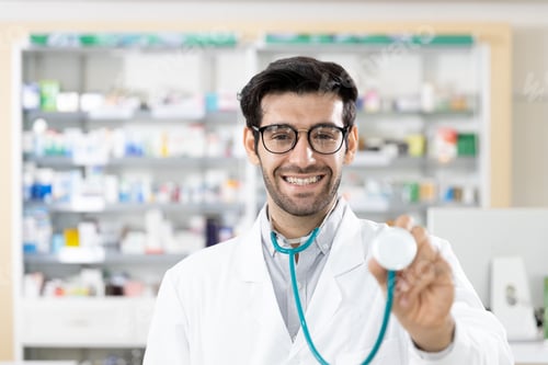 Preview: Portrait Of Middle Eastern Male Pharmacist Standing And Smile Looking Camera With Stethoscope At