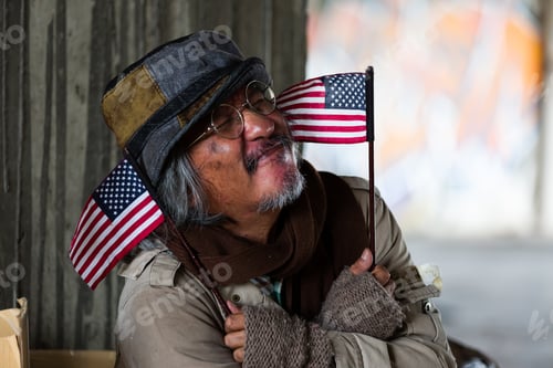 Preview: Homeless Elderly Man Wearing Hat Sitting, Smiling And Holding Flag Usa