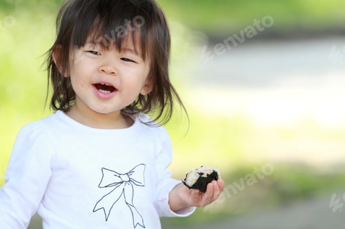 Preview: Japanese Girl Eating Rice Ball (1 Year Old)