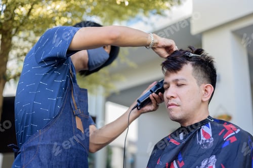 Preview: Asian Businessman Making Haircut At Home. Outdoor Barbershop In Garden. Social Distancing And New