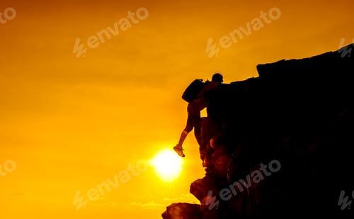 Preview: Business Success And Goal Concept. Silhouette Climber On The Cliff. Copy Space For Text On Sunset