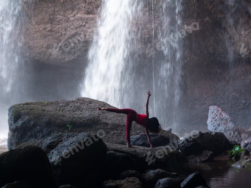 Preview: Asian Woman Practicing Or Doing Yoga At The Waterfall. Beautiful Landscape, Natural Background