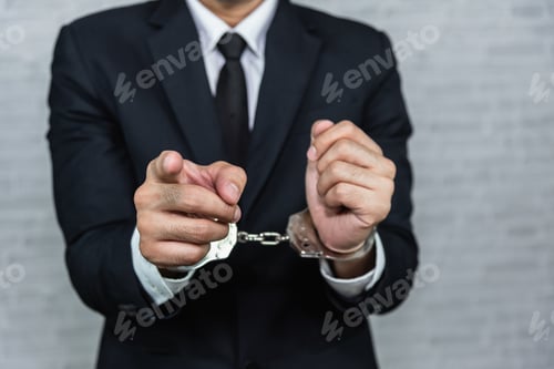 Preview: Businessman In Handcuffs Arrested Isolated On Gray Background