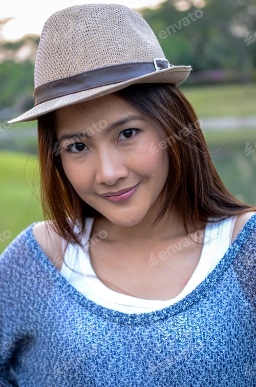 Preview: Beautiful Asian Woman With Hat In The Garden