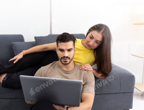 Preview: Couple Relaxing at Home with a Laptop