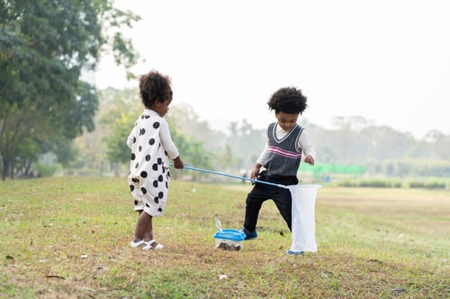 Preview: Happy African American Little Boy And Girl Holding Dustpan And Collecting Trash Into A Bag. Group