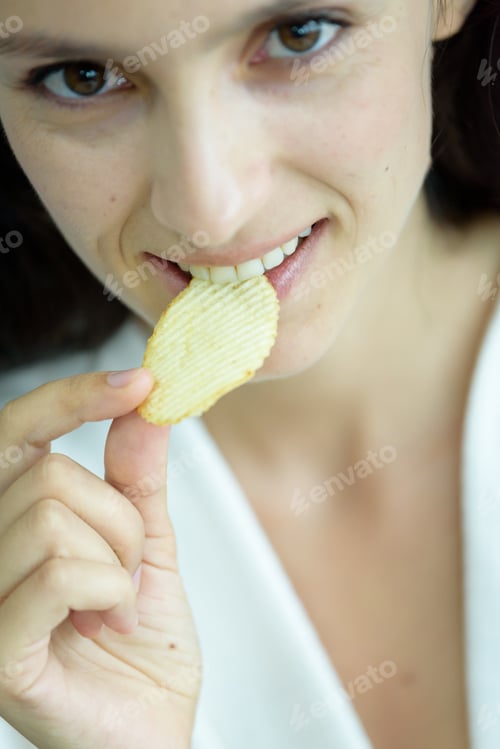Preview: A Beautiful Woman Wearing A Towel And A White Bathrobe Has To Eat A Snack Potato With Happy And