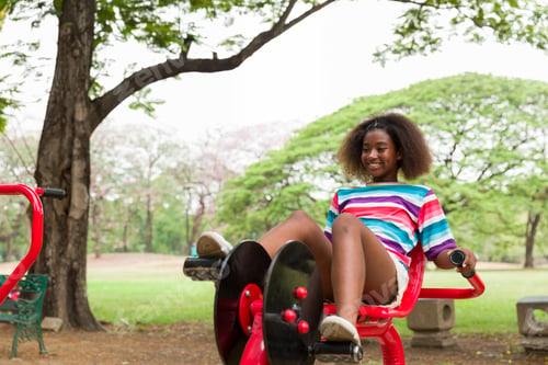 Preview: Cute African American Girl With Curly Hair Playing At The Playground In The Park.