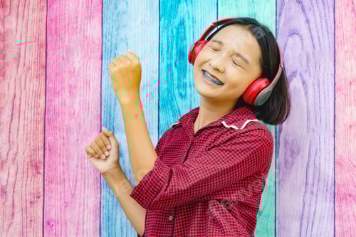 Preview: Happy Young Girl Listening To Music With Colorful Background.