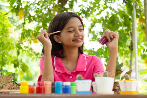 Preview: Young Asia Girl Painting Pot At Garden.