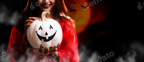 Preview: Happy Halloween. Beautiful Woman Costume And Holding Pumpkin. Copy Space On Dark Background.