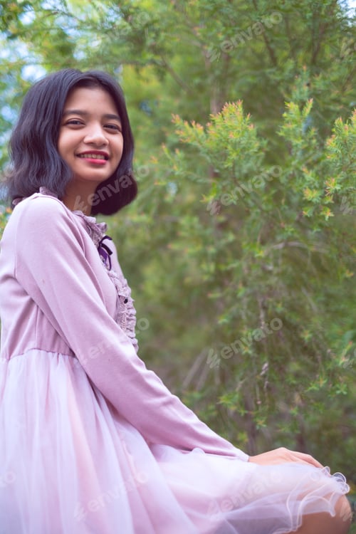 Preview: Portraits Smiling Asian Young Girl With Pine Tree In Vintage Color.