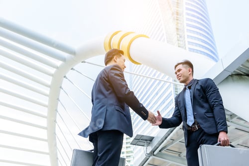 Preview: Two Asian Business Have Handshake With Building And City Background.