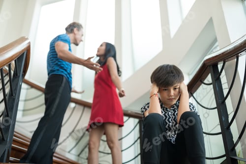 Preview: The Boy Sit On The Stairs At Home, Parents Quarrel. Family Problems Concept
